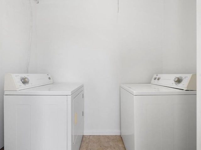 850 Threadneedle St Unit 78, Houston, TX 77079 - washroom with washer and clothes dryer and light tile patterned floors
