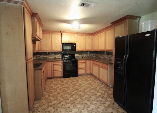 6615 Live Oak Dr, Freeport, TX 77541 - kitchen with black appliances, light brown cabinets, tasteful backsplash, and a textured ceiling