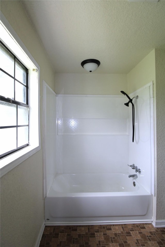 6615 Live Oak Dr, Freeport, TX 77541 - bathroom with shower / bathtub combination and a textured ceiling
