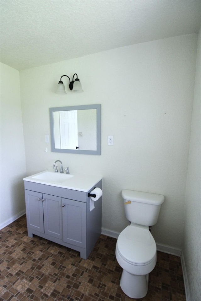 6615 Live Oak Dr, Freeport, TX 77541 - bathroom featuring vanity and a textured ceiling