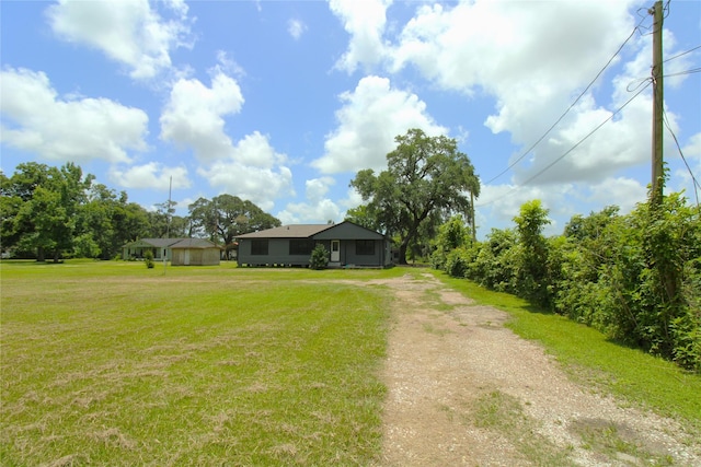 6615 Live Oak Dr, Freeport, TX 77541 - view of front of home with dirt driveway and a front yard