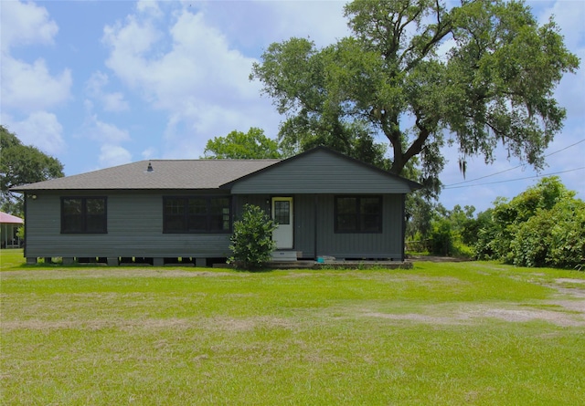 6615 Live Oak Dr, Freeport, TX 77541 - view of front of home with a front lawn and a shingled roof
