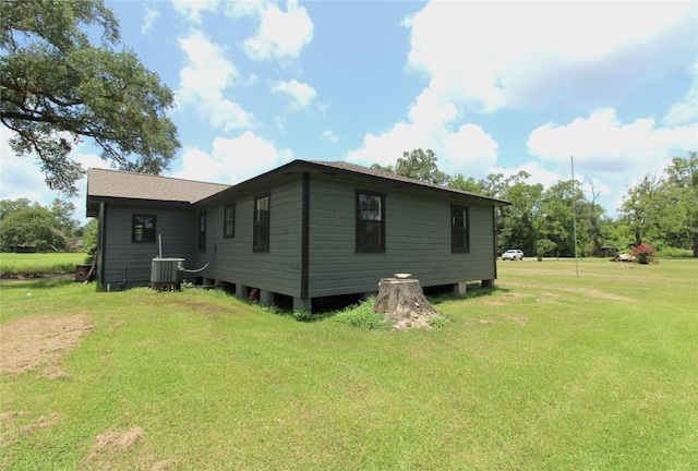 6615 Live Oak Dr, Freeport, TX 77541 - view of side of property with a lawn and a cooling unit