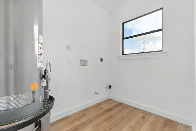 1311 E 35th St, Houston, TX 77022 - laundry room featuring water heater, electric dryer hookup, light wood-style floors, and hookup for a washing machine