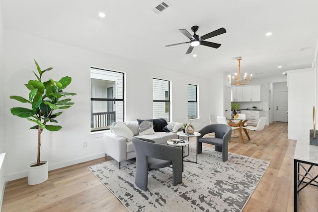 1311 E 35th St, Houston, TX 77022 - living room with a chandelier, light wood finished floors, a ceiling fan, recessed lighting, and vaulted ceiling