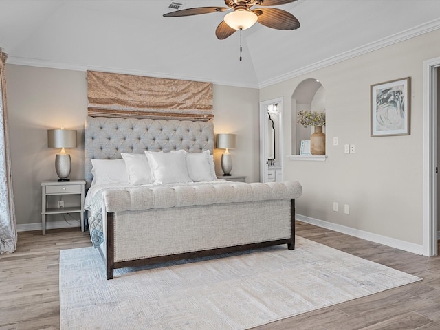 441 Jeanie Lynne Cir, Galveston, TX 77554 - bedroom with wood finished floors, arched walkways, a ceiling fan, vaulted ceiling, and ensuite bathroom