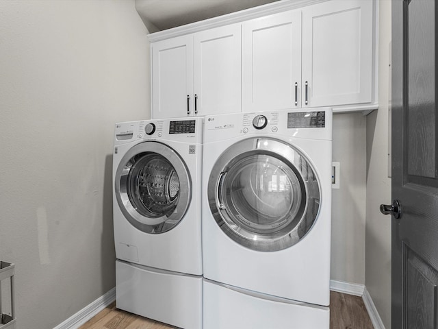 441 Jeanie Lynne Cir, Galveston, TX 77554 - laundry room with washer and clothes dryer, cabinet space, and light wood-style flooring