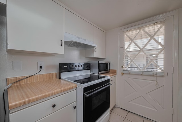 12633 Memorial Dr Unit 250, Houston, TX 77024 - kitchen with electric range oven, under cabinet range hood, stainless steel microwave, light countertops, and light tile patterned floors