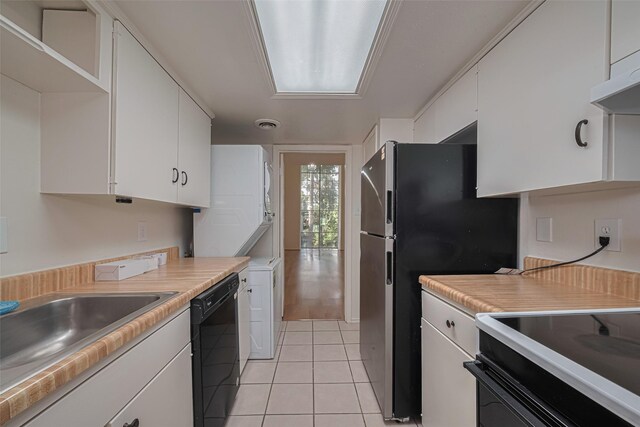 12633 Memorial Dr Unit 250, Houston, TX 77024 - kitchen with black dishwasher, white cabinets, light tile patterned flooring, and light countertops