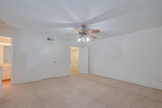 12633 Memorial Dr Unit 250, Houston, TX 77024 - unfurnished bedroom with light colored carpet, a spacious closet, ensuite bathroom, and ceiling fan