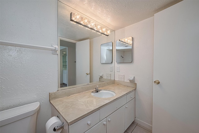 12633 Memorial Dr Unit 250, Houston, TX 77024 - bathroom with vanity, a textured wall, a textured ceiling, and tile patterned flooring