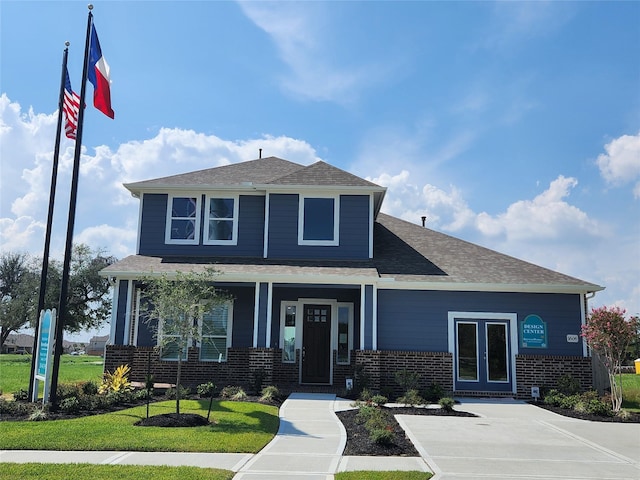 1606 Friendship Park Cir, Seabrook, TX 77586 - view of front of home with brick siding, covered porch, a front lawn, and roof with shingles