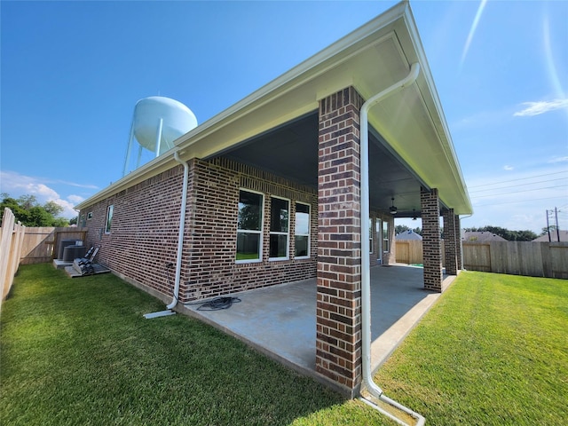 1606 Friendship Park Cir, Seabrook, TX 77586 - view of side of home with brick siding, a patio area, a fenced backyard, and ceiling fan