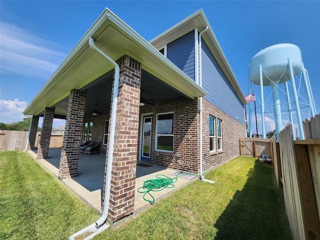 1606 Friendship Park Cir, Seabrook, TX 77586 - rear view of house with a ceiling fan, a patio, brick siding, and a fenced backyard
