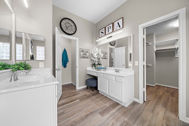 15026 Grape Orchard Ct, Cypress, TX 77433 - full bathroom with wood finished floors, two vanities, and a walk in closet