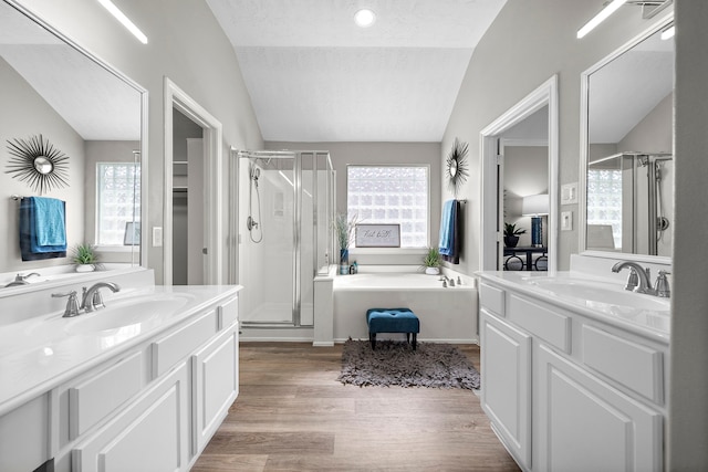 15026 Grape Orchard Ct, Cypress, TX 77433 - full bathroom with lofted ceiling, a stall shower, wood finished floors, and two vanities