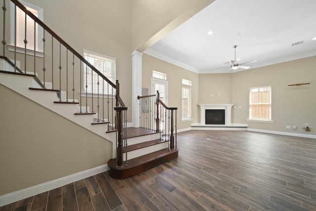 1148 Du Barry Ln, Houston, TX 77018 - staircase with ceiling fan, wood finished floors, plenty of natural light, crown molding, and a glass covered fireplace