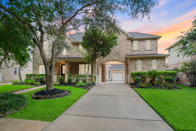 10522 Ginger Gln, Missouri City, TX 77459 - traditional-style home with a yard, driveway, a balcony, and brick siding