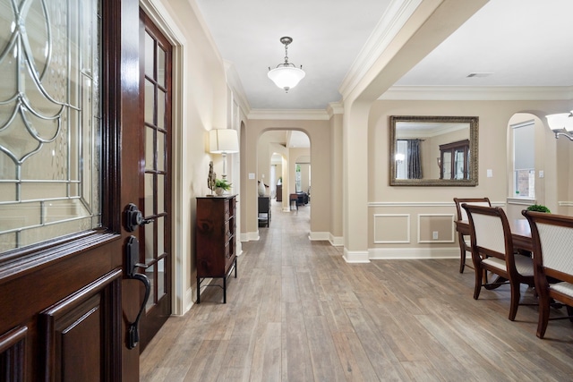 10522 Ginger Gln, Missouri City, TX 77459 - entrance foyer with arched walkways, light wood-type flooring, and crown molding