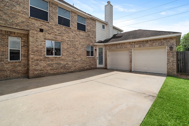 10522 Ginger Gln, Missouri City, TX 77459 - view of front facade featuring brick siding, driveway, an attached garage, and a chimney