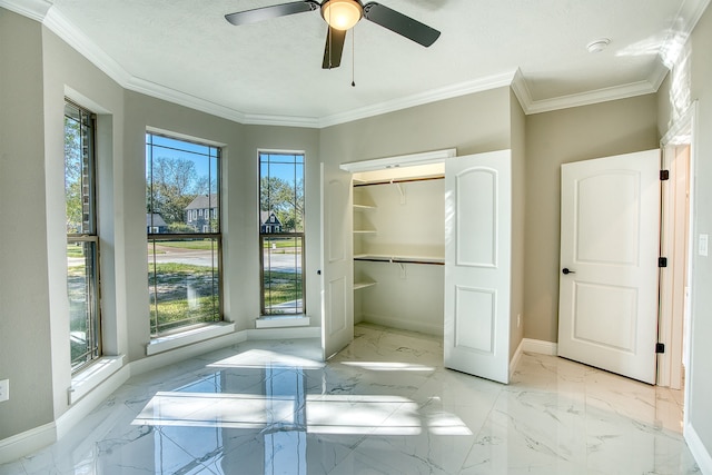 255 W Caldwood Dr, Beaumont, TX 77707 - unfurnished bedroom featuring light marble finish flooring, ornamental molding, a ceiling fan, a spacious closet, and a closet