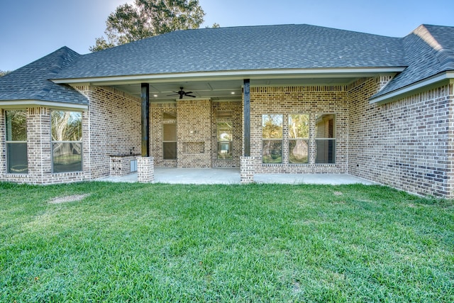 255 W Caldwood Dr, Beaumont, TX 77707 - rear view of property featuring ceiling fan, brick siding, a patio, a lawn, and a shingled roof