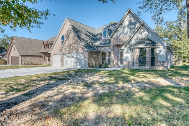 255 W Caldwood Dr, Beaumont, TX 77707 - english style home featuring brick siding, an attached garage, driveway, a front lawn, and a shingled roof