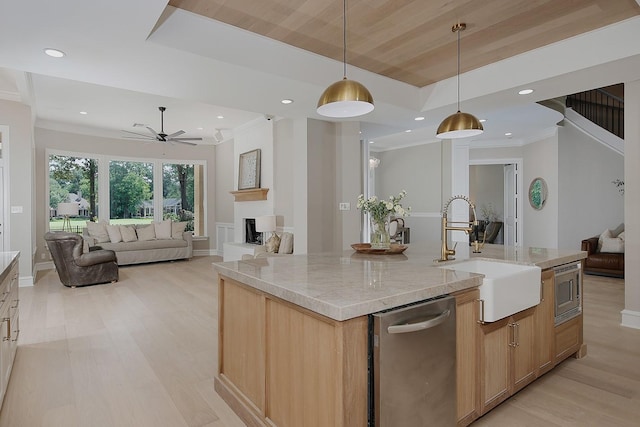 303 S Silvershire Cir, The Woodlands, TX 77381 - kitchen featuring appliances with stainless steel finishes, open floor plan, light brown cabinets, light wood finished floors, and recessed lighting