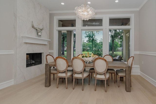 303 S Silvershire Cir, The Woodlands, TX 77381 - dining room with wood finished floors, a chandelier, ornamental molding, a high end fireplace, and recessed lighting