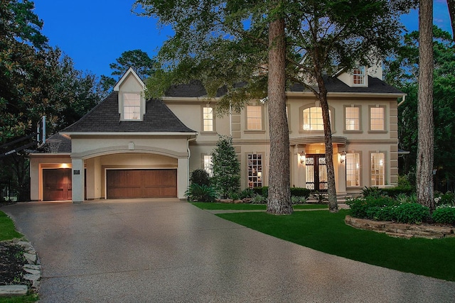 303 S Silvershire Cir, The Woodlands, TX 77381 - view of front of home featuring stucco siding, driveway, a garage, and a front yard