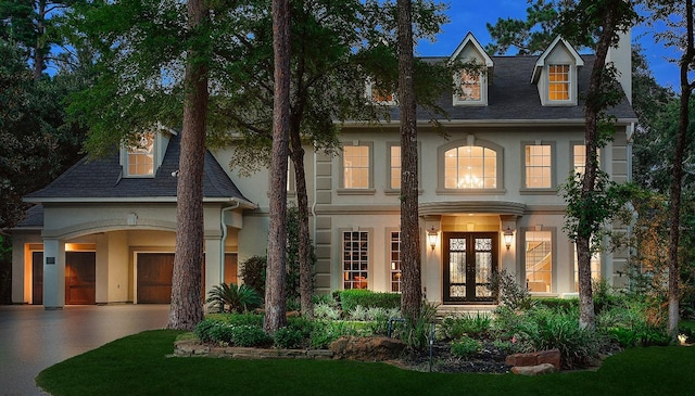 303 S Silvershire Cir, The Woodlands, TX 77381 - view of front of property with french doors, stucco siding, driveway, and a shingled roof