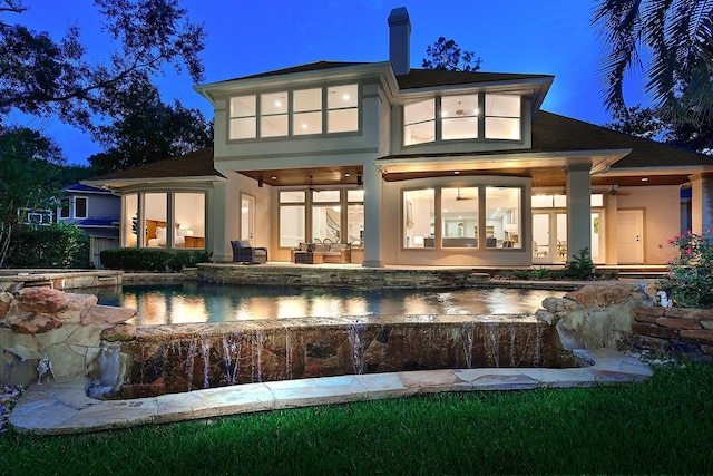 303 S Silvershire Cir, The Woodlands, TX 77381 - rear view of property with a ceiling fan, an outdoor pool, stucco siding, an in-ground hot tub, and a chimney
