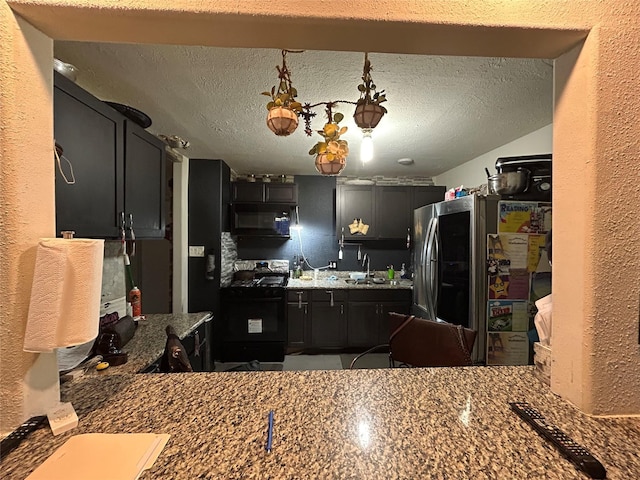 1114 Elton St, Houston, TX 77034 - kitchen with black appliances, a textured wall, dark cabinets, and a textured ceiling