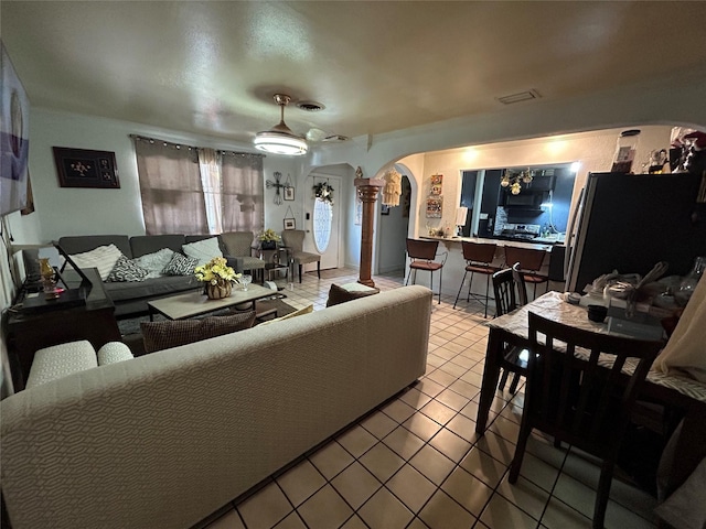 1114 Elton St, Houston, TX 77034 - living room with tile patterned flooring, arched walkways, ceiling fan, and ornate columns