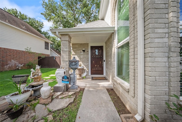 10135 Wayward Wind Ln, Houston, TX 77064 - doorway to property featuring brick siding and roof with shingles