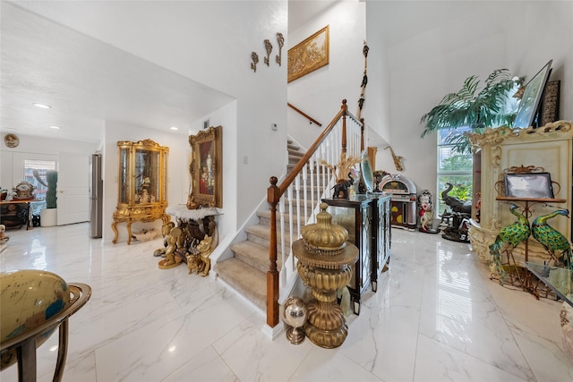 10135 Wayward Wind Ln, Houston, TX 77064 - stairway with healthy amount of natural light, marble tiled flooring, a towering ceiling, and recessed lighting