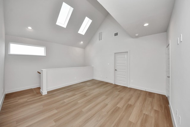 3003A Ventas Dr, Houston, TX 77047 - empty room featuring a skylight, light wood-style floors, recessed lighting, and high vaulted ceiling