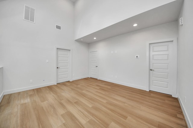 3003A Ventas Dr, Houston, TX 77047 - empty room with light wood finished floors, recessed lighting, and a towering ceiling