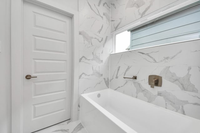 3003A Ventas Dr, Houston, TX 77047 - bathroom featuring marble finish flooring and a tub to relax in