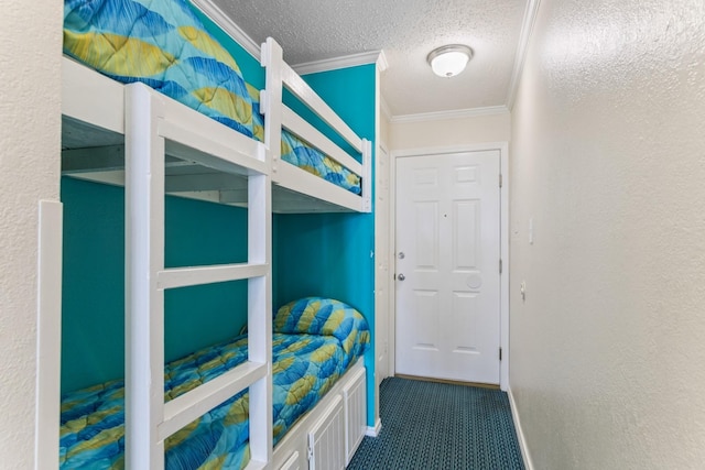 6102 Seawall Blvd Unit 105, Galveston, TX 77551 - bedroom with ornamental molding, a textured ceiling, and carpet flooring