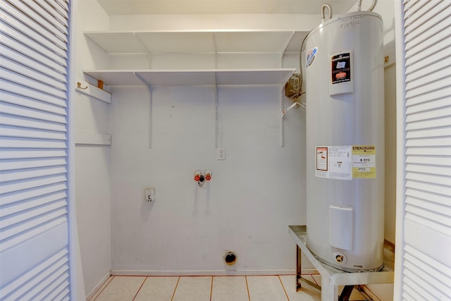 22619 Rockgate Dr, Spring, TX 77373 - laundry room with electric water heater, electric dryer hookup, washer hookup, and light tile patterned floors