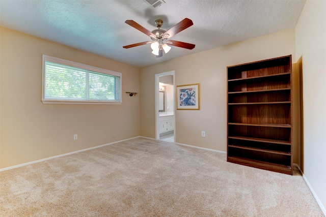 22619 Rockgate Dr, Spring, TX 77373 - unfurnished bedroom featuring carpet flooring, ensuite bath, a textured ceiling, and a ceiling fan