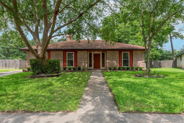 22619 Rockgate Dr, Spring, TX 77373 - ranch-style home featuring a tile roof, brick siding, and a chimney
