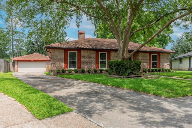 22619 Rockgate Dr, Spring, TX 77373 - single story home featuring a tile roof, an outbuilding, a chimney, and a garage