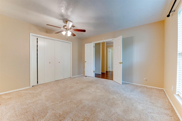 22619 Rockgate Dr, Spring, TX 77373 - unfurnished bedroom with carpet flooring, a closet, ceiling fan, and a textured ceiling