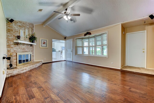22619 Rockgate Dr, Spring, TX 77373 - unfurnished living room featuring a ceiling fan, wood-type flooring, a textured ceiling, and a brick fireplace