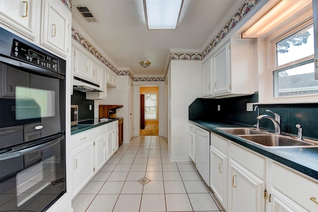22619 Rockgate Dr, Spring, TX 77373 - kitchen featuring dark countertops, black appliances, white cabinetry, under cabinet range hood, and backsplash