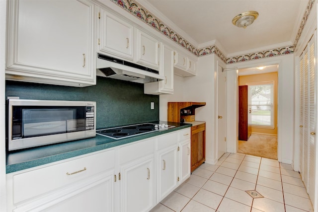 22619 Rockgate Dr, Spring, TX 77373 - kitchen featuring electric stovetop, stainless steel microwave, under cabinet range hood, and white cabinetry
