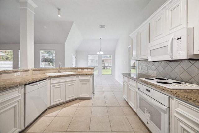 8211 Broken Timber Way, Houston, TX 77095 - kitchen featuring white appliances, decorative backsplash, light tile patterned flooring, vaulted ceiling, and healthy amount of natural light