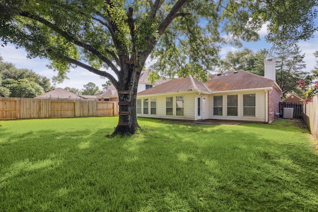 8211 Broken Timber Way, Houston, TX 77095 - back of house with a fenced backyard, a chimney, and brick siding